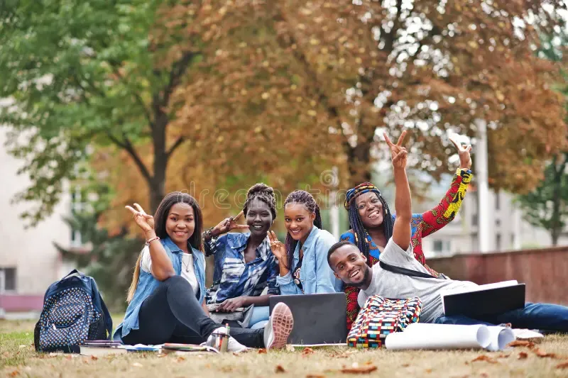 group-five-african-college-students-spending-time-together-campus-university-yard-black-afro-friends-sitting-grass-219663908